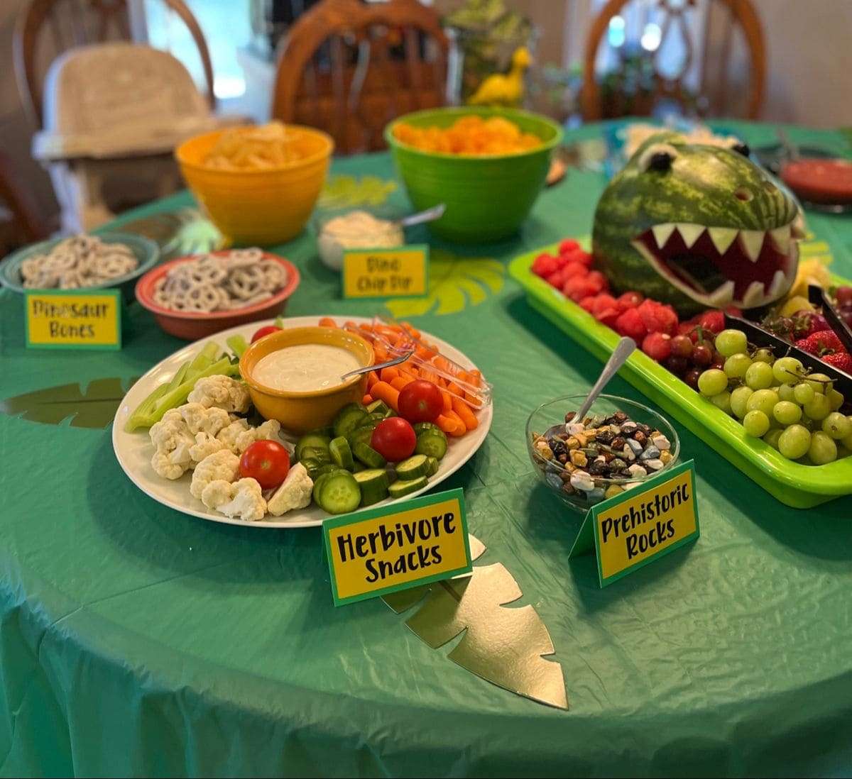 Roaring Fun! How to Organize the Perfect Dinosaur Party for Your Little Explorer 7 Dinosaur party food spread with cupcakes and snacks