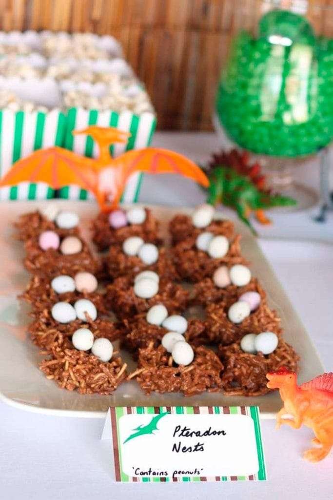 Best First and Second Birthday Party Ideas for Boys and Girls 105 Chocolate pudding “dirt” cups with toy dinosaurs on top—fun Dino Dig cups snack idea.