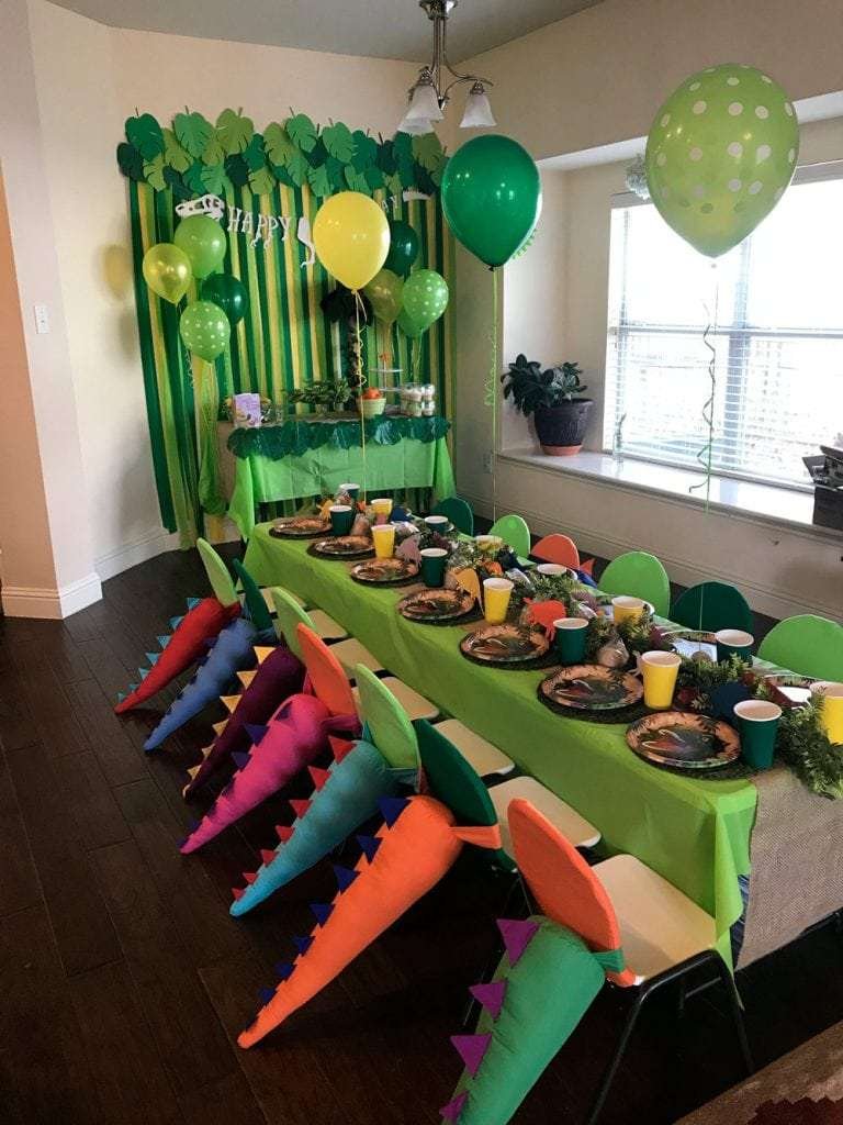 Best First and Second Birthday Party Ideas for Boys and Girls 103 Kids celebrating a dinosaur birthday with photo