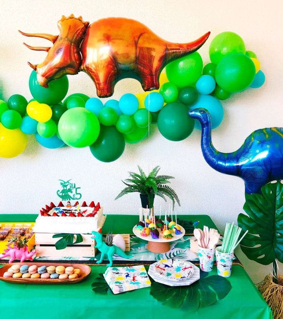 Best First and Second Birthday Party Ideas for Boys and Girls 106 Kids celebrating a dinosaur birthday with photo