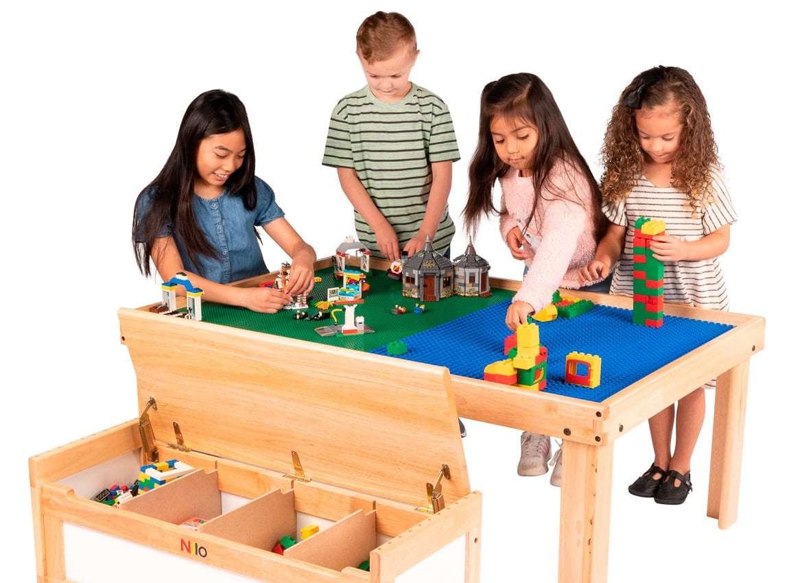 Children building with blocks at a construction-themed table