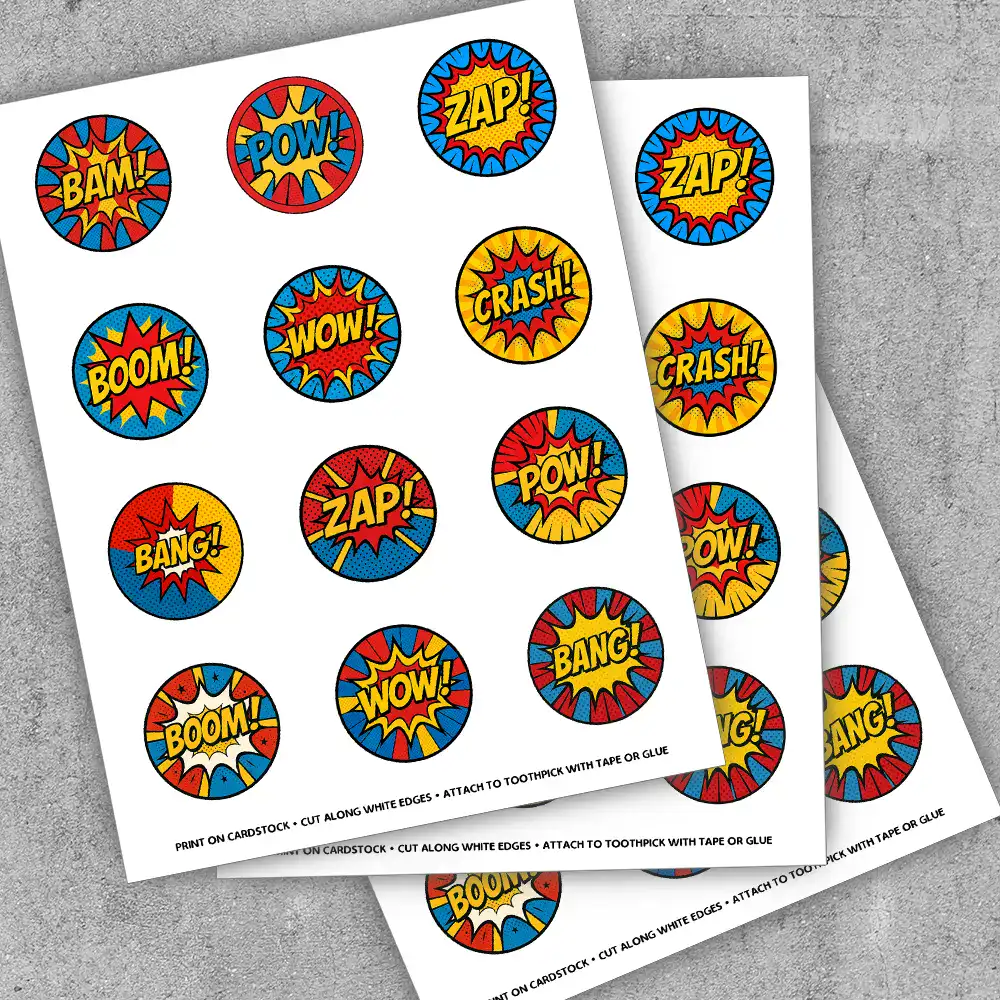 Close-up of 2-inch superhero toppers featuring bold red, blue, and yellow designs