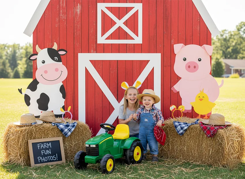 Farm party photo booth with barn backdrop and toddler-friendly props