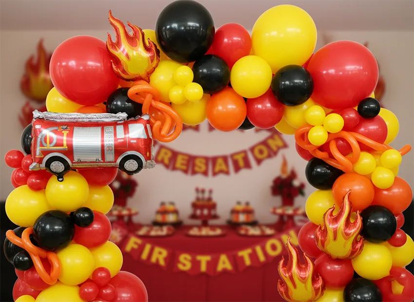 Firefighter birthday party balloon arch in red yellow and orange