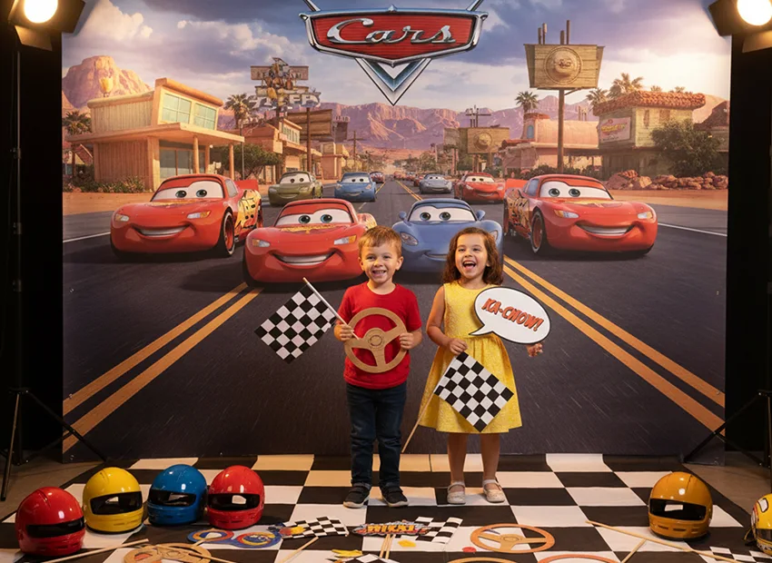 Cars birthday party photo booth with racing props and checkered flags