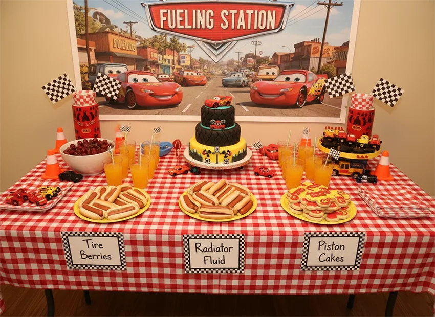 Cars birthday party fueling station food table with checkered decor