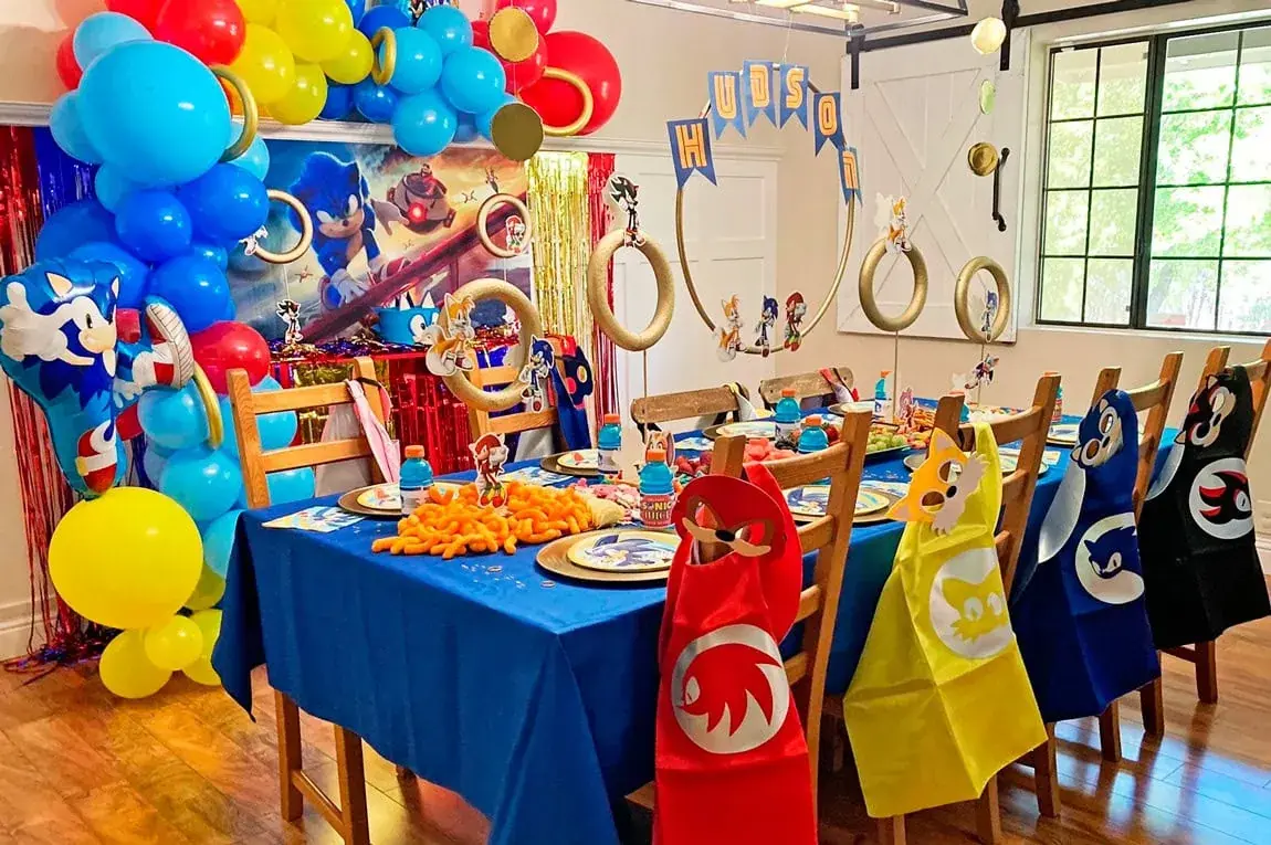 Happy kids at a Sonic-themed party with rings and checkerboard accents